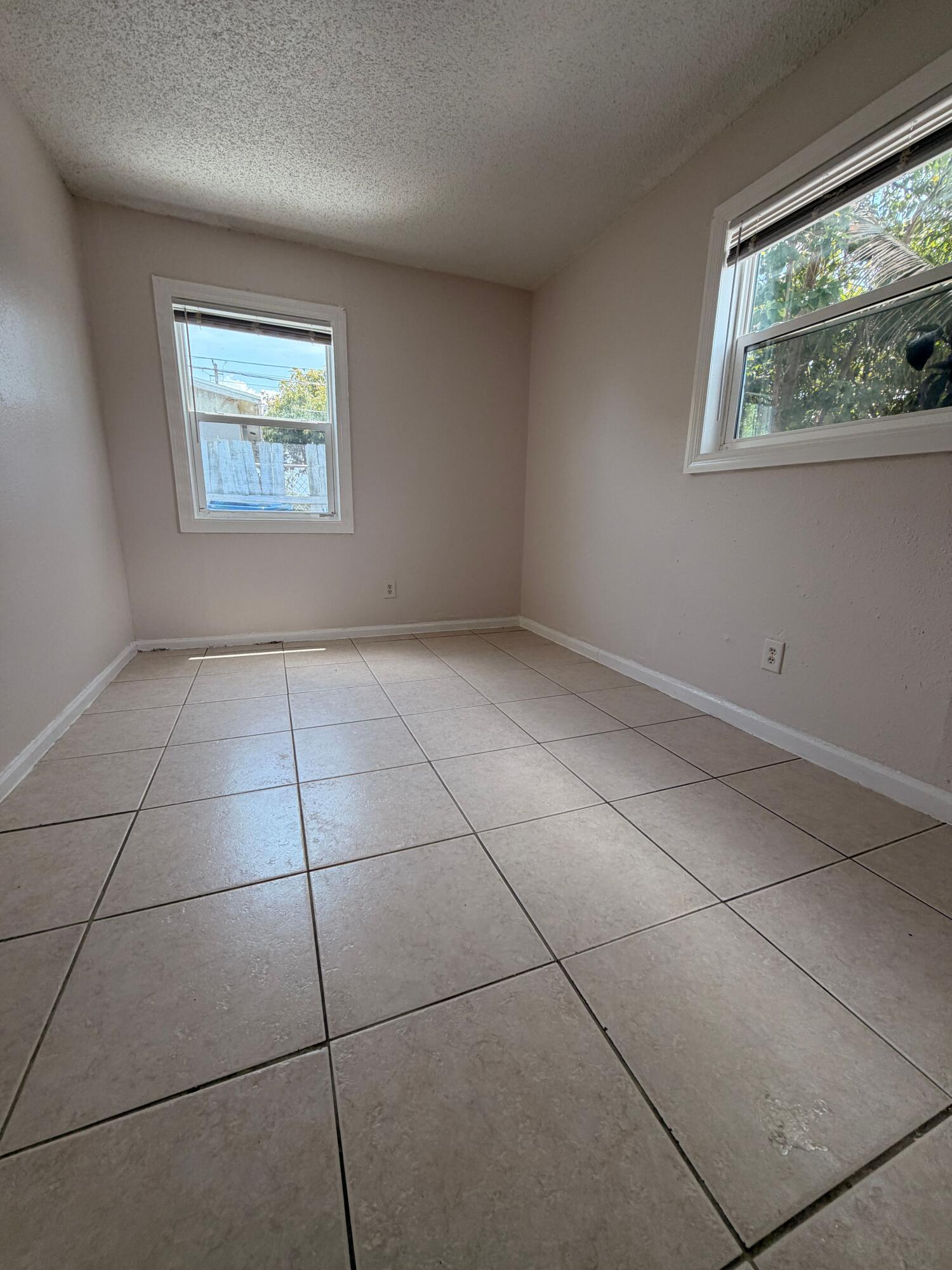 1618 West 26th Court, Unit A Riviera Beach, FL 33404 - Photo 15 of 15 a view of an empty room with a window