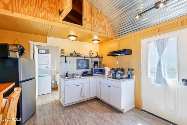 a kitchen with stainless steel appliances a sink and a refrigerator