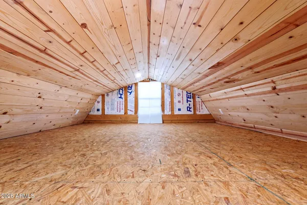 a view of a room with a ceiling fan and window