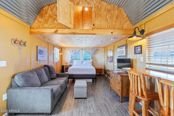a living room with furniture a wooden floor and a table