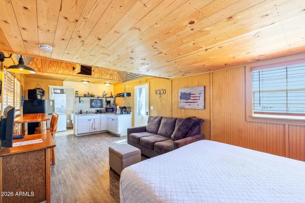 a bedroom with furniture and a wooden floor