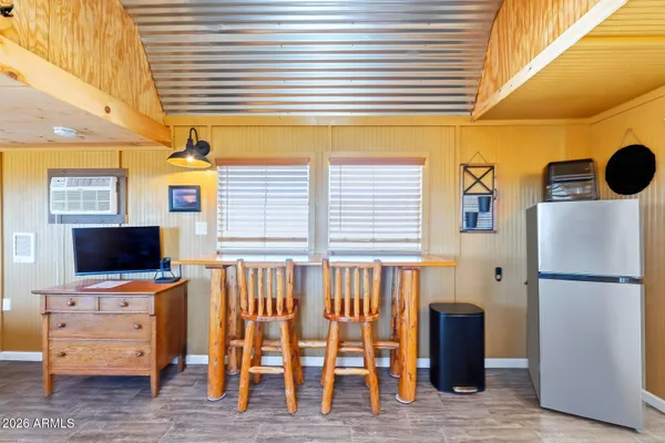 a view of a kitchen with furniture and flat screen tv