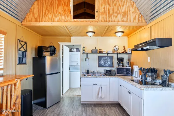 a kitchen with stainless steel appliances kitchen island granite countertop a refrigerator and a stove