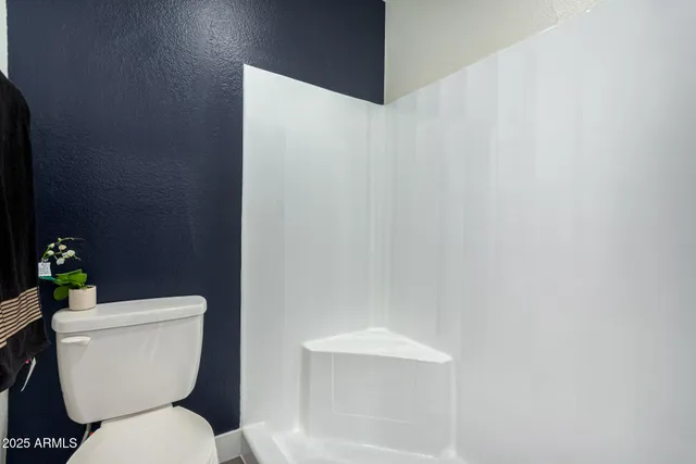 a white toilet sitting next to a white sink