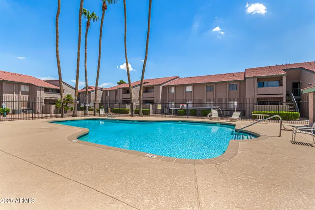 a view of swimming pool with outdoor seating and a patio