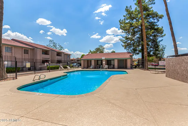 a view of a house with swimming pool and sitting area