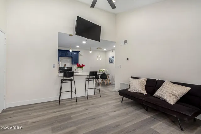 a living room with furniture and a wooden floor