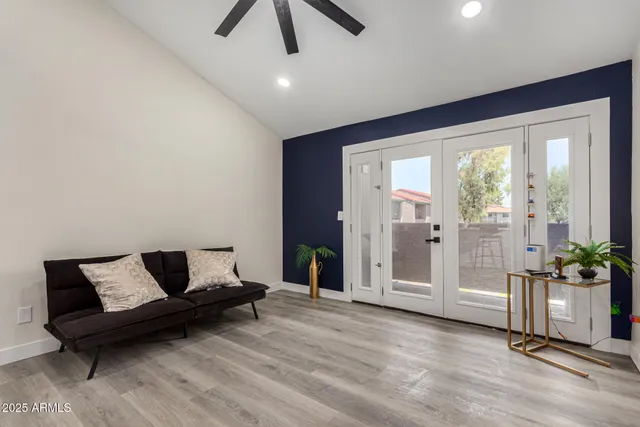 a living room with furniture and wooden floor