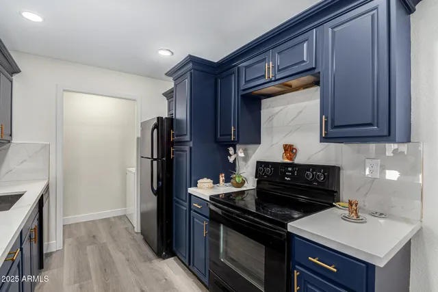 a kitchen with a sink stove and refrigerator