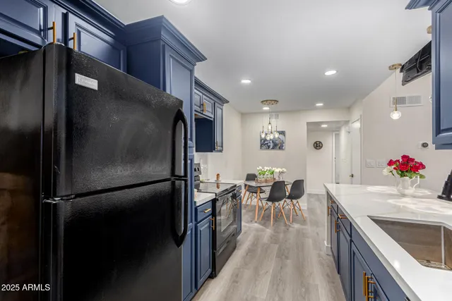a kitchen with a refrigerator and a sink