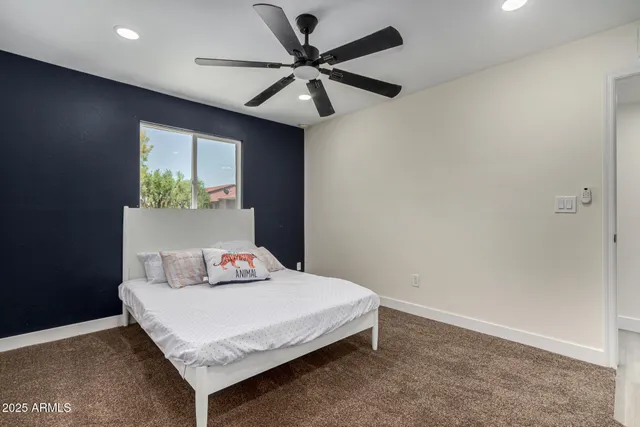 a bedroom with a bed and window