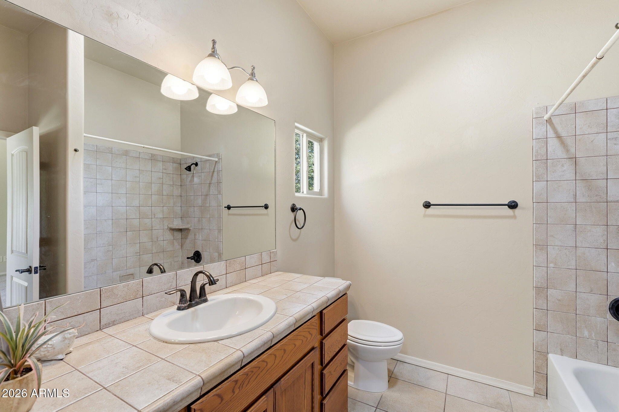 9626 South Turkey Track Road Hereford, AZ 85615 - Photo 26 of 54 a bathroom with a sink a toilet and a mirror