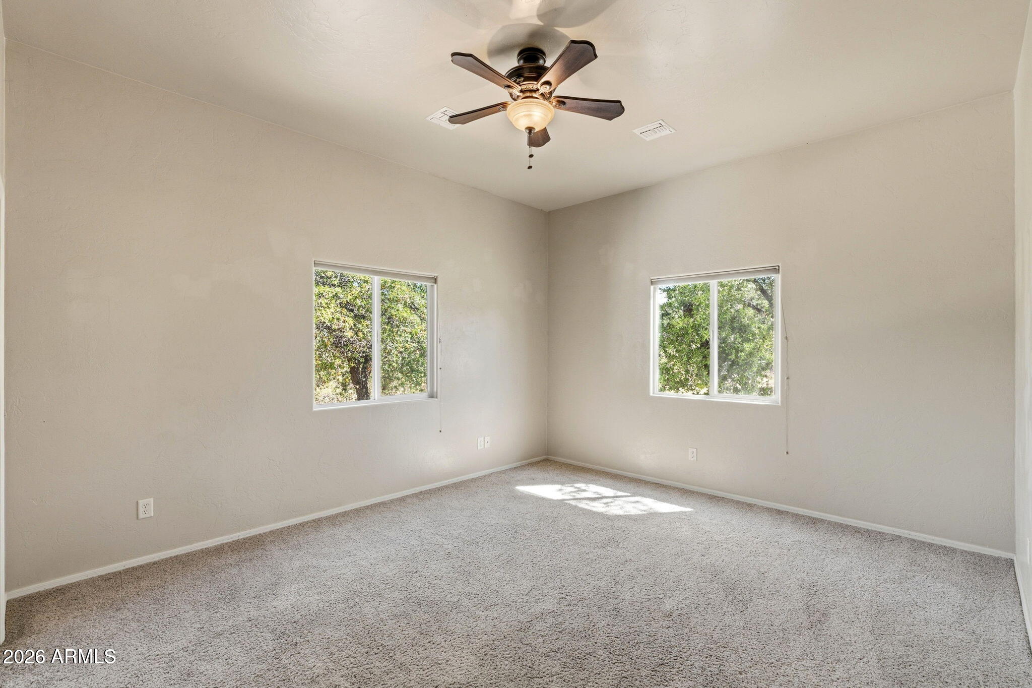 9626 South Turkey Track Road Hereford, AZ 85615 - Photo 28 of 54 an empty room with windows and fan