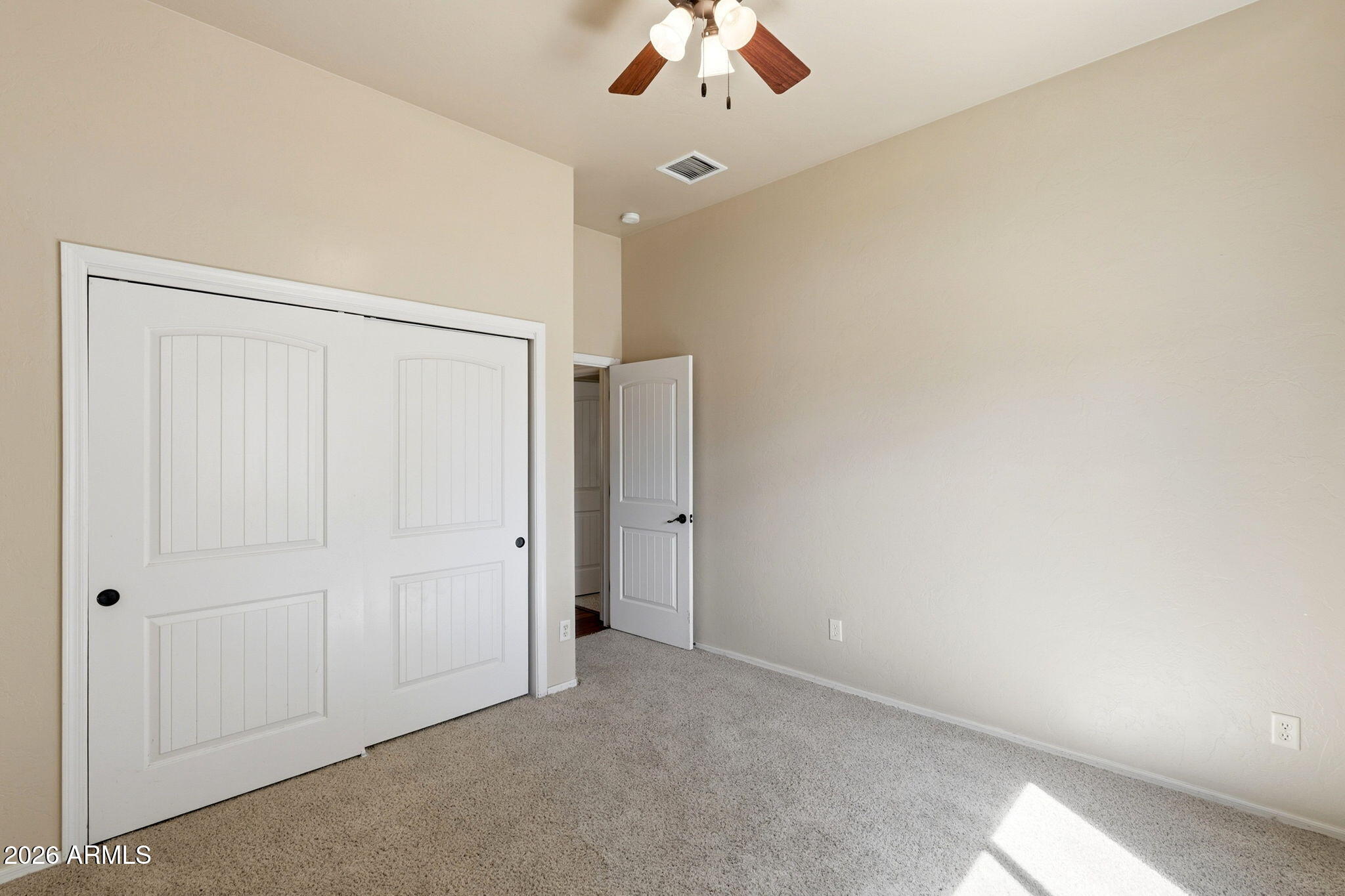 9626 South Turkey Track Road Hereford, AZ 85615 - Photo 32 of 54 an empty room with a ceiling fan and a window