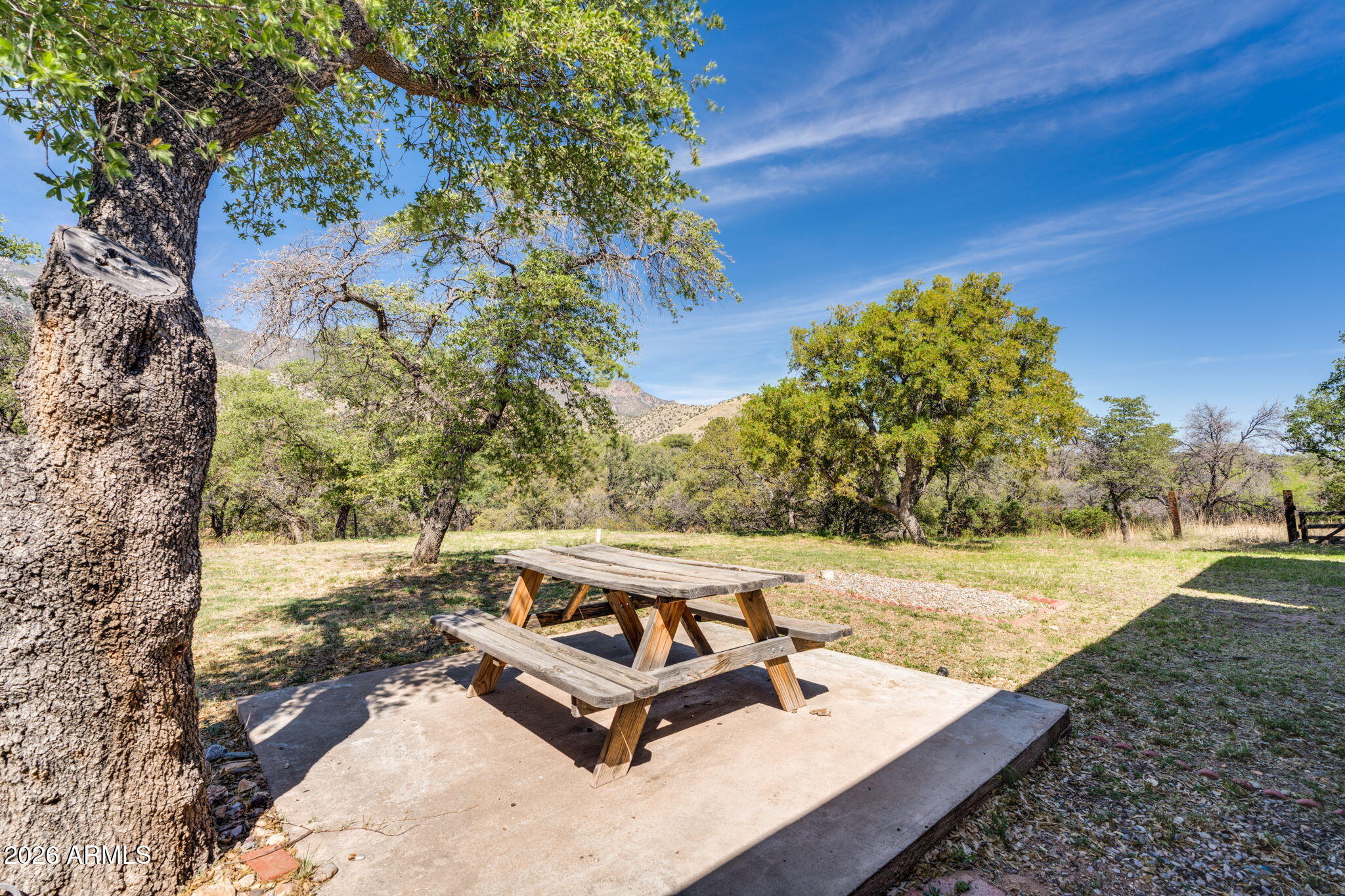 9626 South Turkey Track Road Hereford, AZ 85615 - Photo 37 of 54 a view of a backyard with wooden floor and a bench