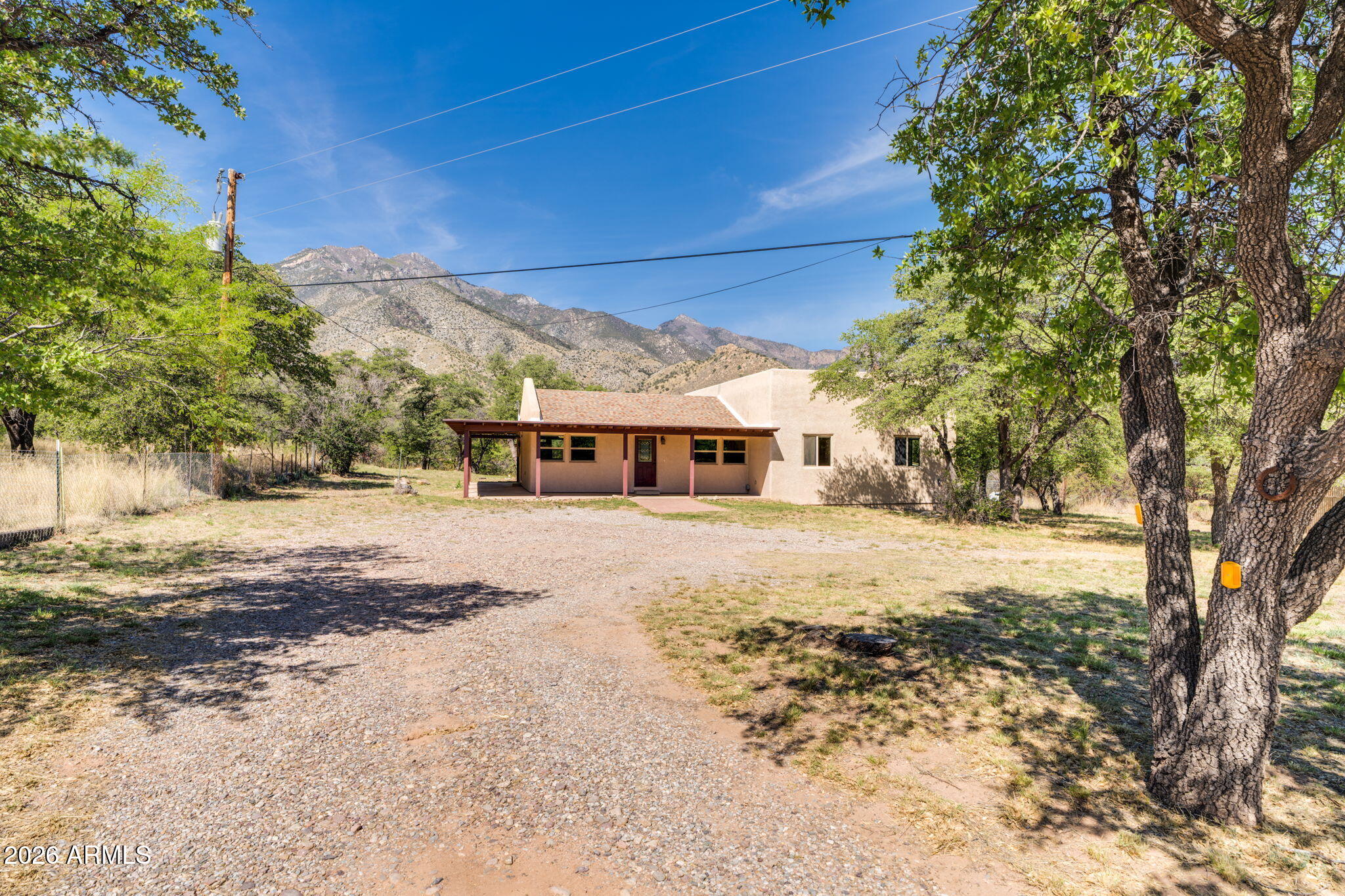 9626 South Turkey Track Road Hereford, AZ 85615 - Photo 9 of 54 a front view of a house with a yard covered in snow