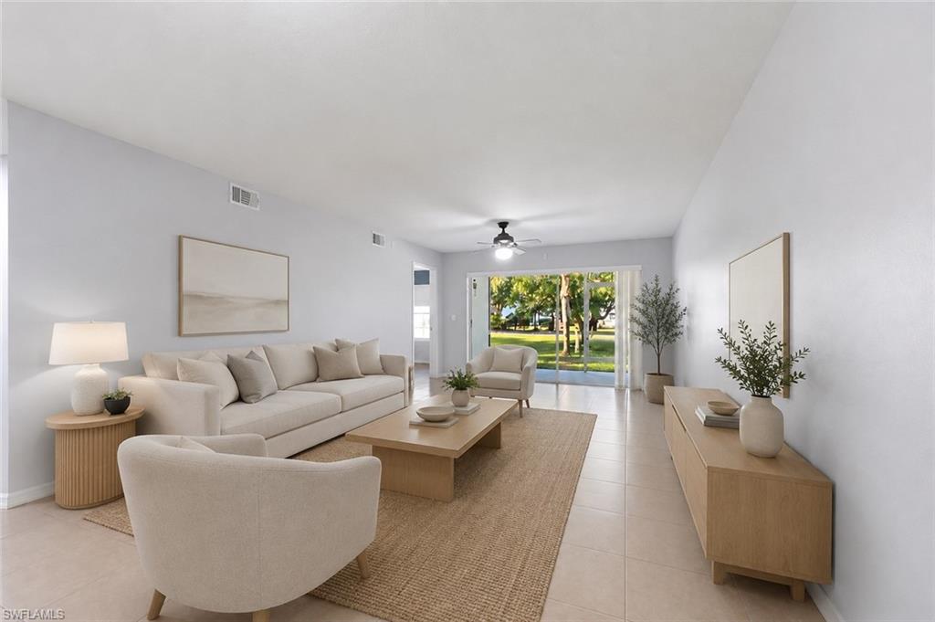 5737 Whitaker Road, Unit C101 Naples, FL 34112 - Photo 3 of 28 a living room with furniture and a large window