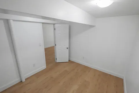 a view of green field with trees in the background