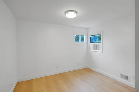a view of a room with a window and a ceiling fan