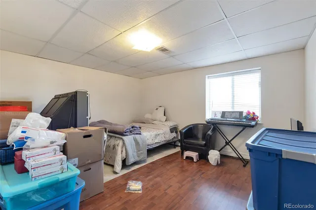 a bedroom with furniture and wooden floor