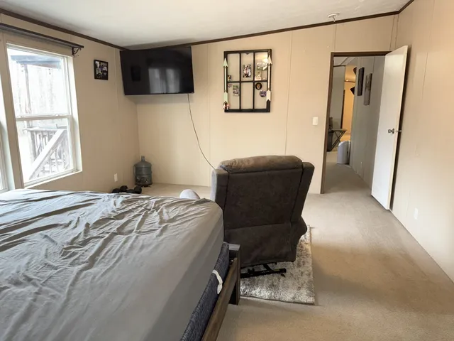 a living room with furniture a air conditioner and a window