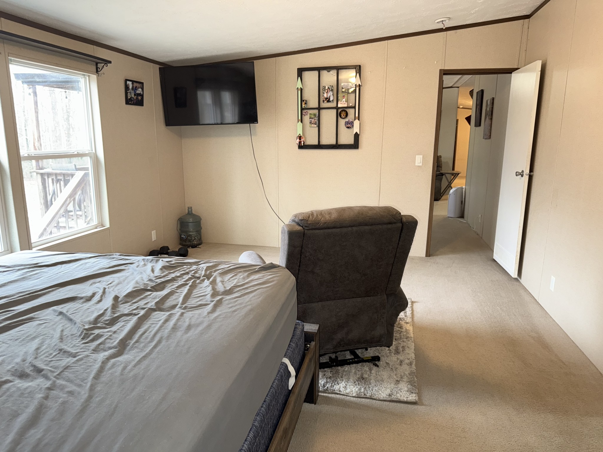 239 Henderson Road Hohenwald, TN 38462 - Photo 20 of 61 a bedroom with a bed and a chair