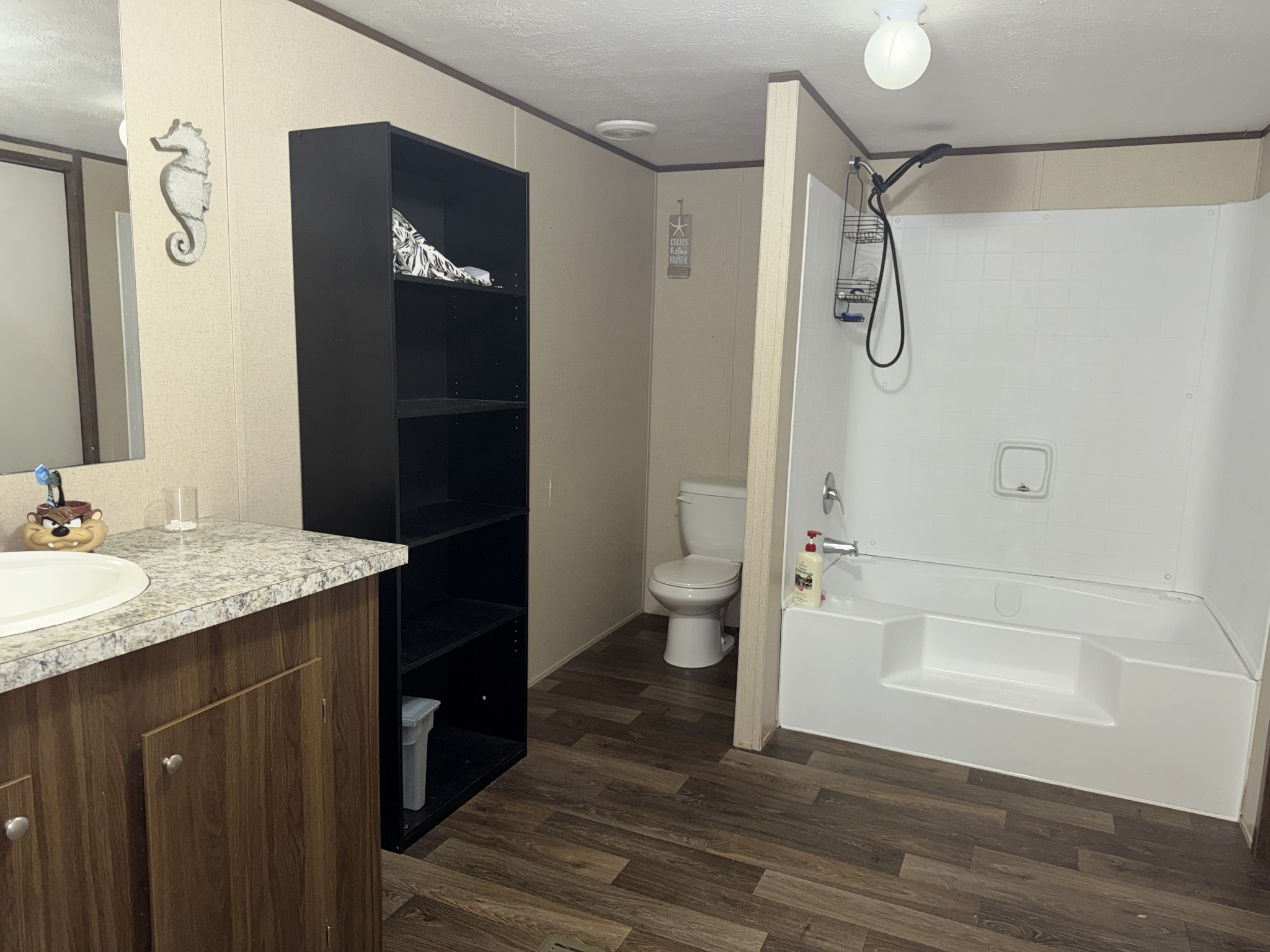 239 Henderson Road Hohenwald, TN 38462 - Photo 21 of 61 a bathroom with a granite countertop sink toilet and shower
