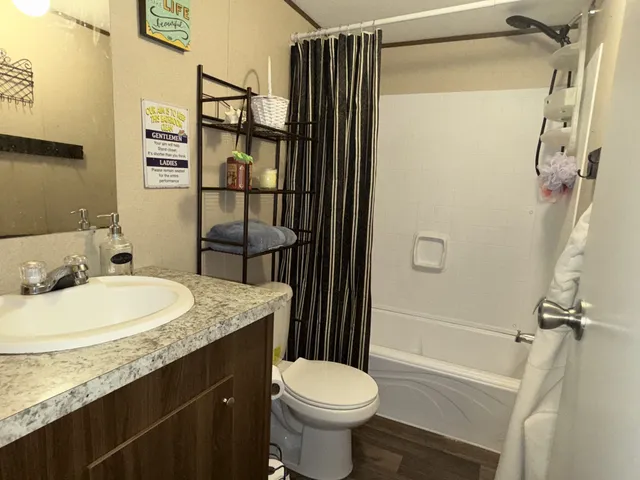 a bedroom with bed and a chandelier