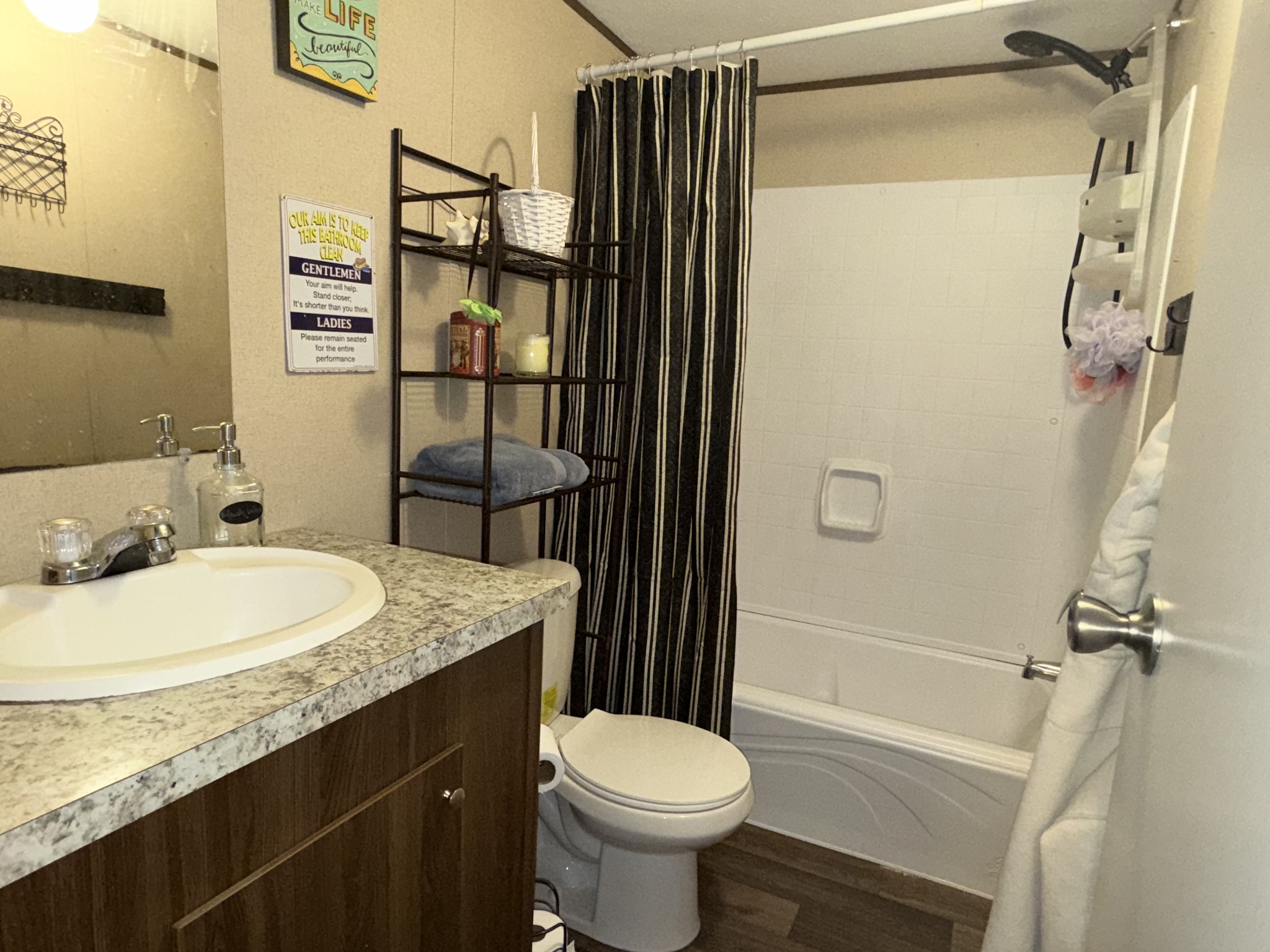 239 Henderson Road Hohenwald, TN 38462 - Photo 26 of 61 a bathroom with a granite countertop sink toilet and shower