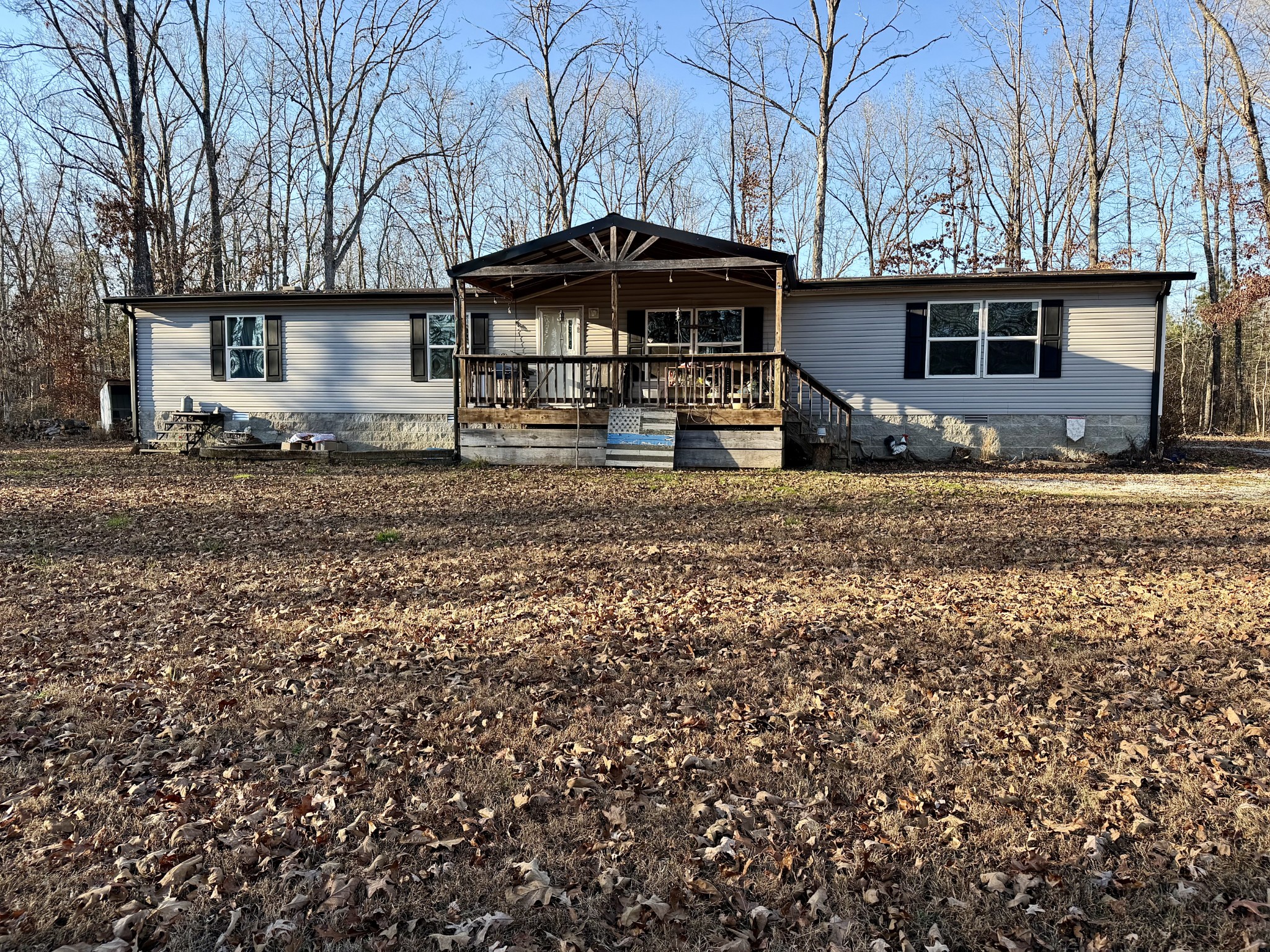 239 Henderson Road Hohenwald, TN 38462 - Photo 4 of 61 a front view of a house with garden