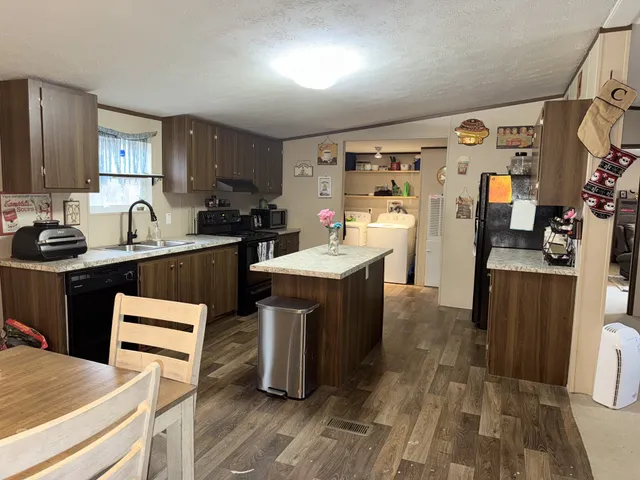 a kitchen with a sink a stove and cabinets