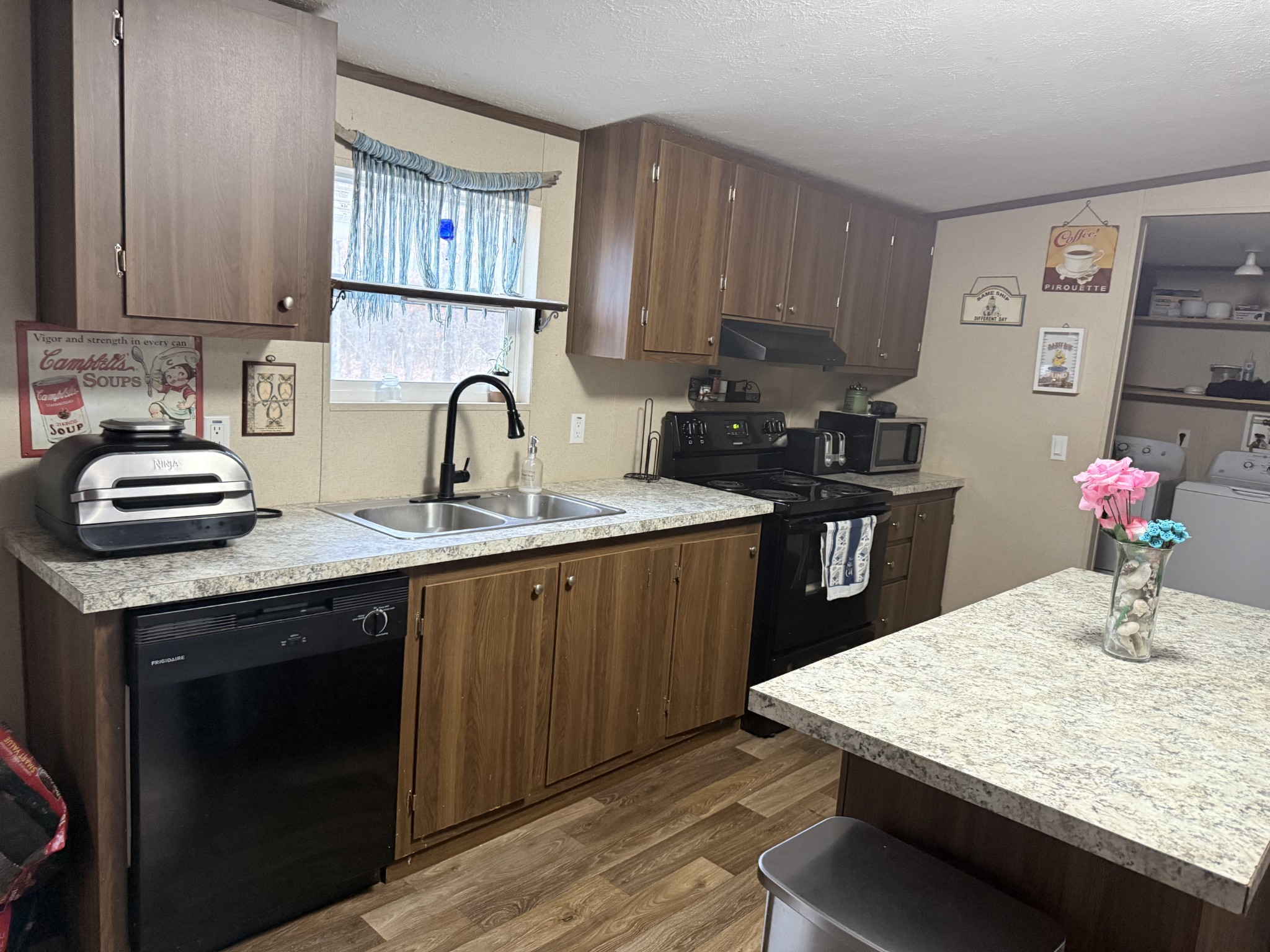 239 Henderson Road Hohenwald, TN 38462 - Photo 7 of 61 a kitchen with a sink a stove and cabinets