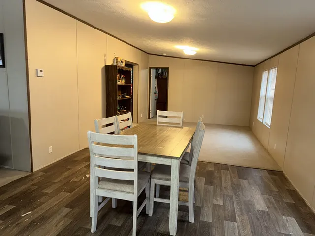 an empty room with furniture and window