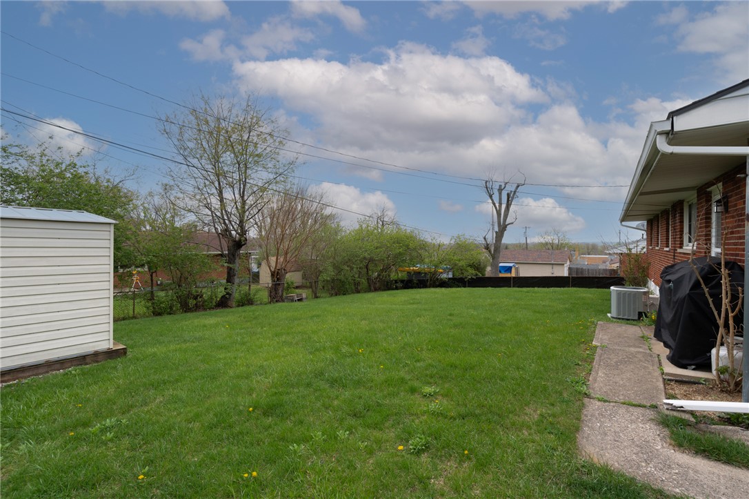 795 Spring Garden Place Dayton, OH 45431 - Photo 10 of 34 This spacious green backyard offers ample room for outdoor activities and future enhancements.