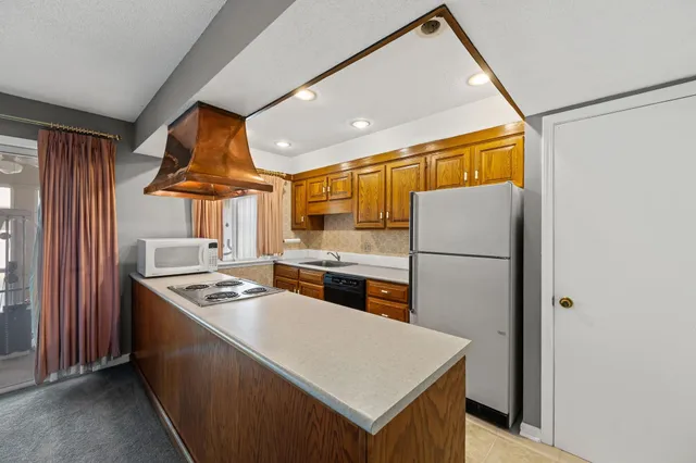 a kitchen that has a cabinets and a stove