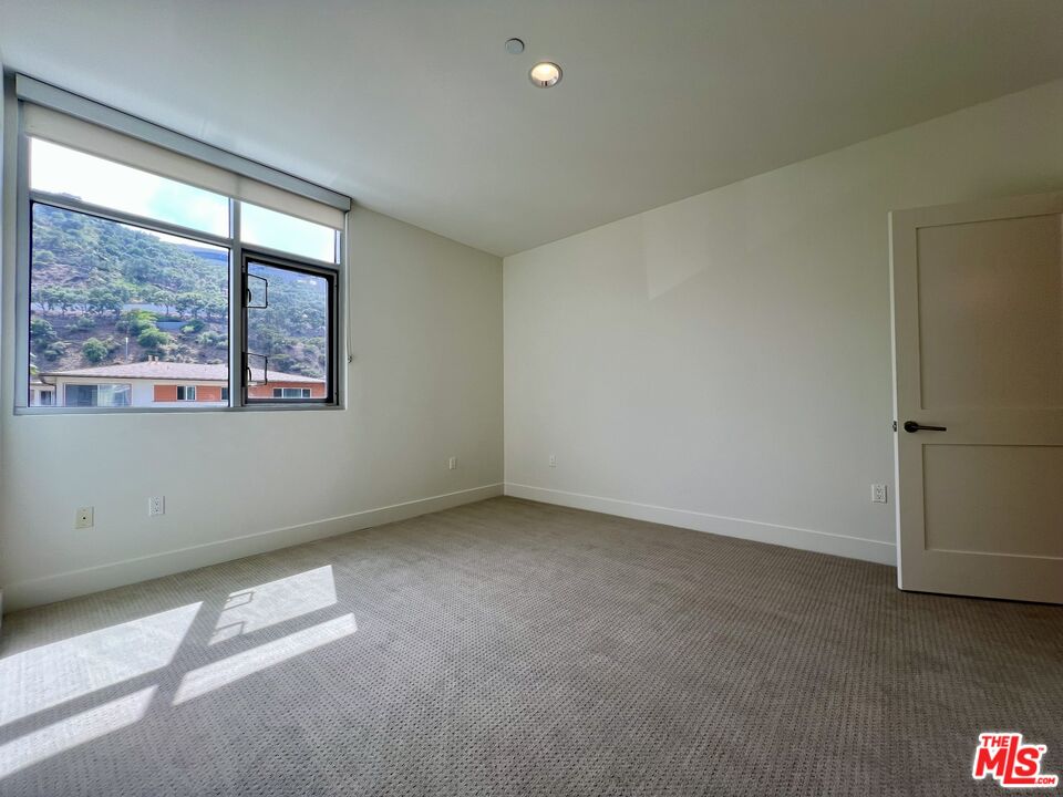 11715 Bellagio Road, Unit 204 Los Angeles, CA 90049 - Photo 9 of 27 an empty room with a window