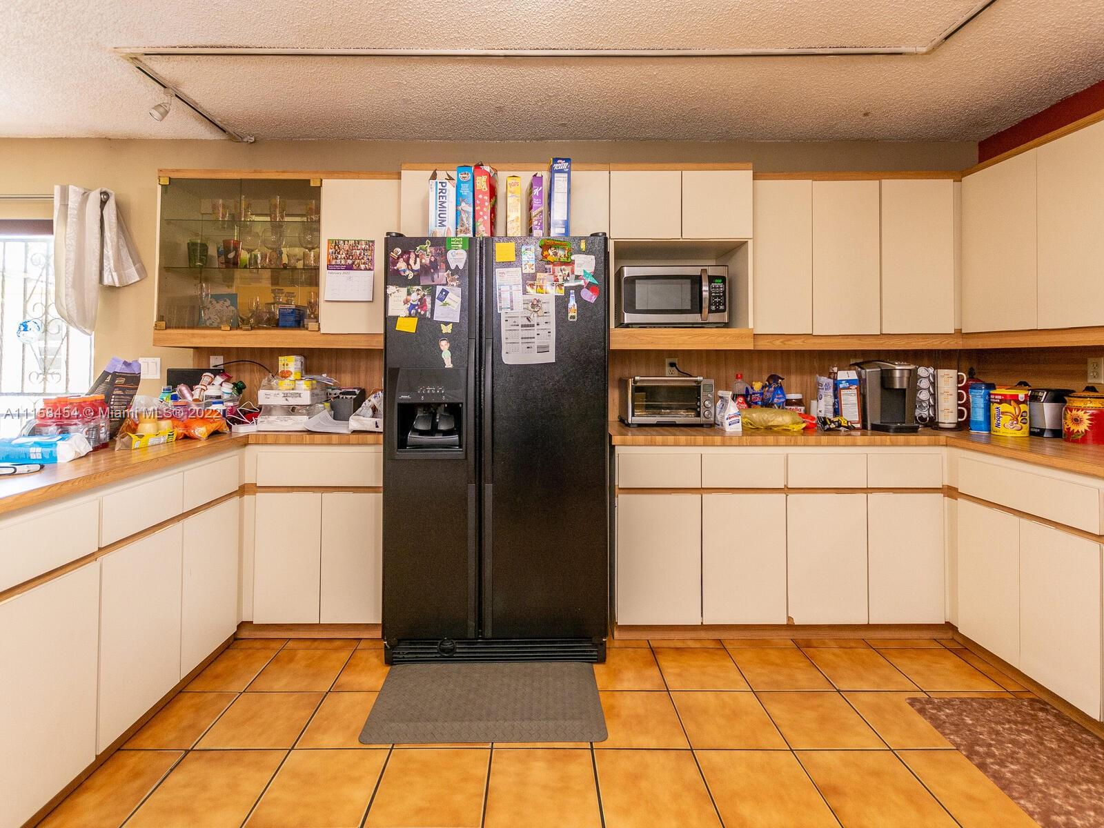 6731 Southwest 5th Terrace Miami, FL 33144 - Photo 17 of 33 a kitchen with refrigerator and window