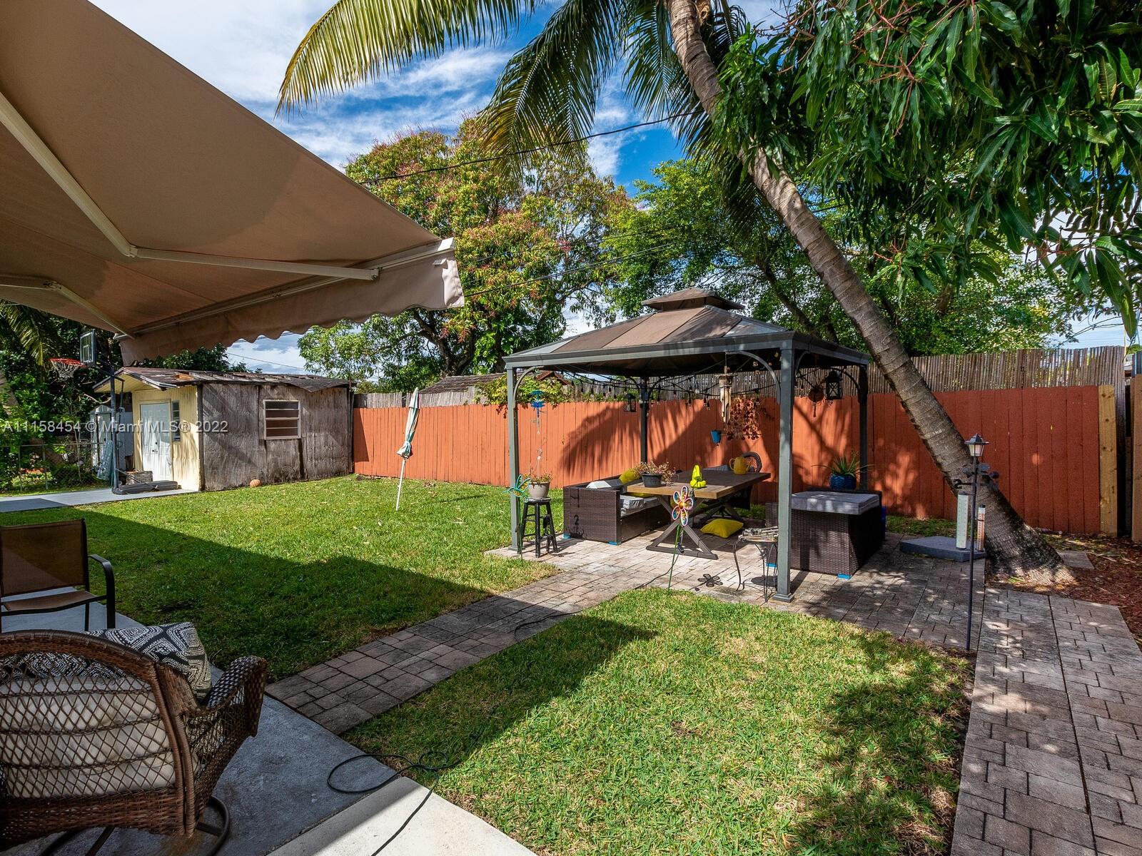 6731 Southwest 5th Terrace Miami, FL 33144 - Photo 25 of 33 a view of a chair and table in backyard of the house