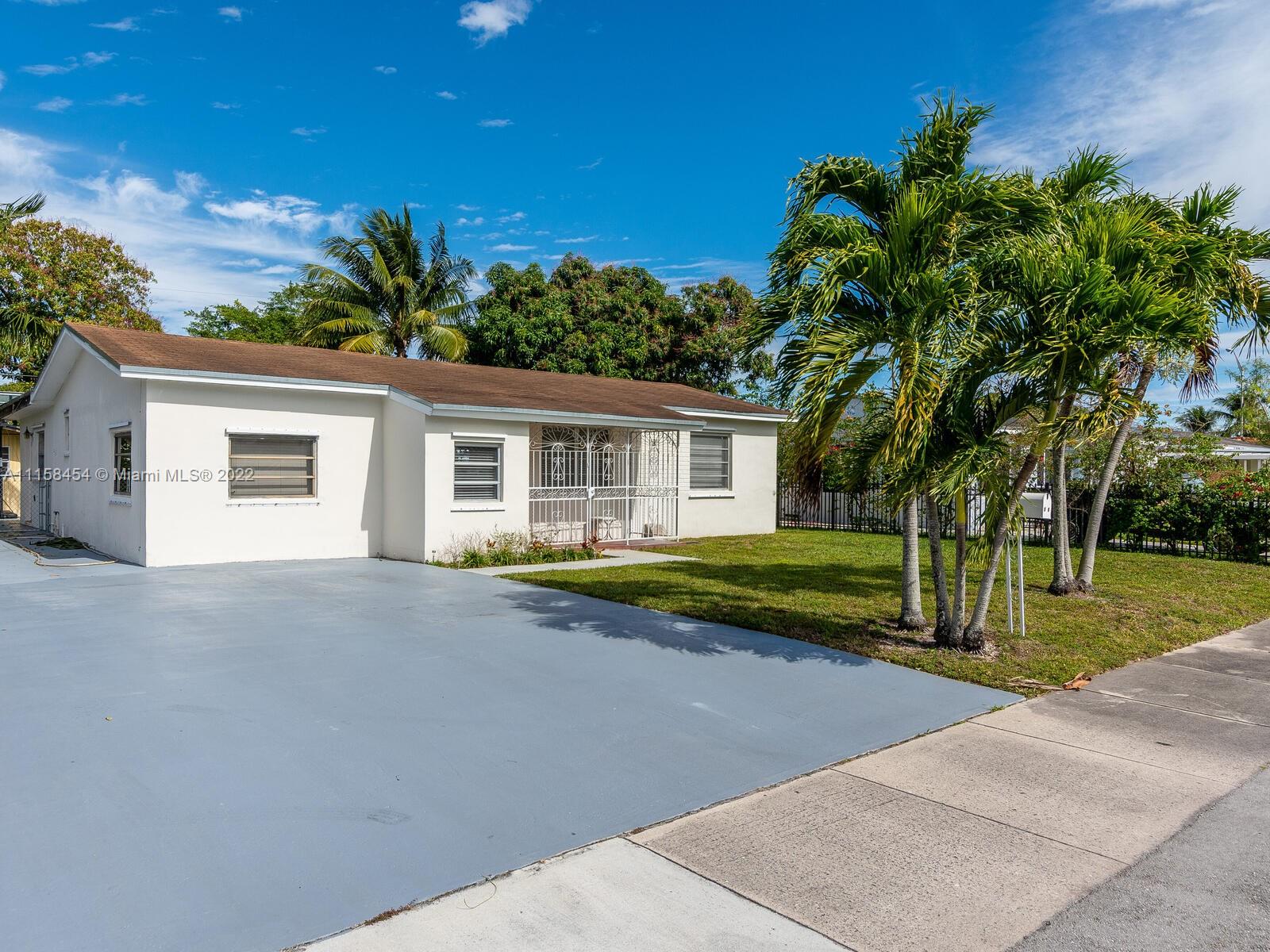 6731 Southwest 5th Terrace Miami, FL 33144 - Photo 3 of 33 a view of a house with palm trees and a small yard