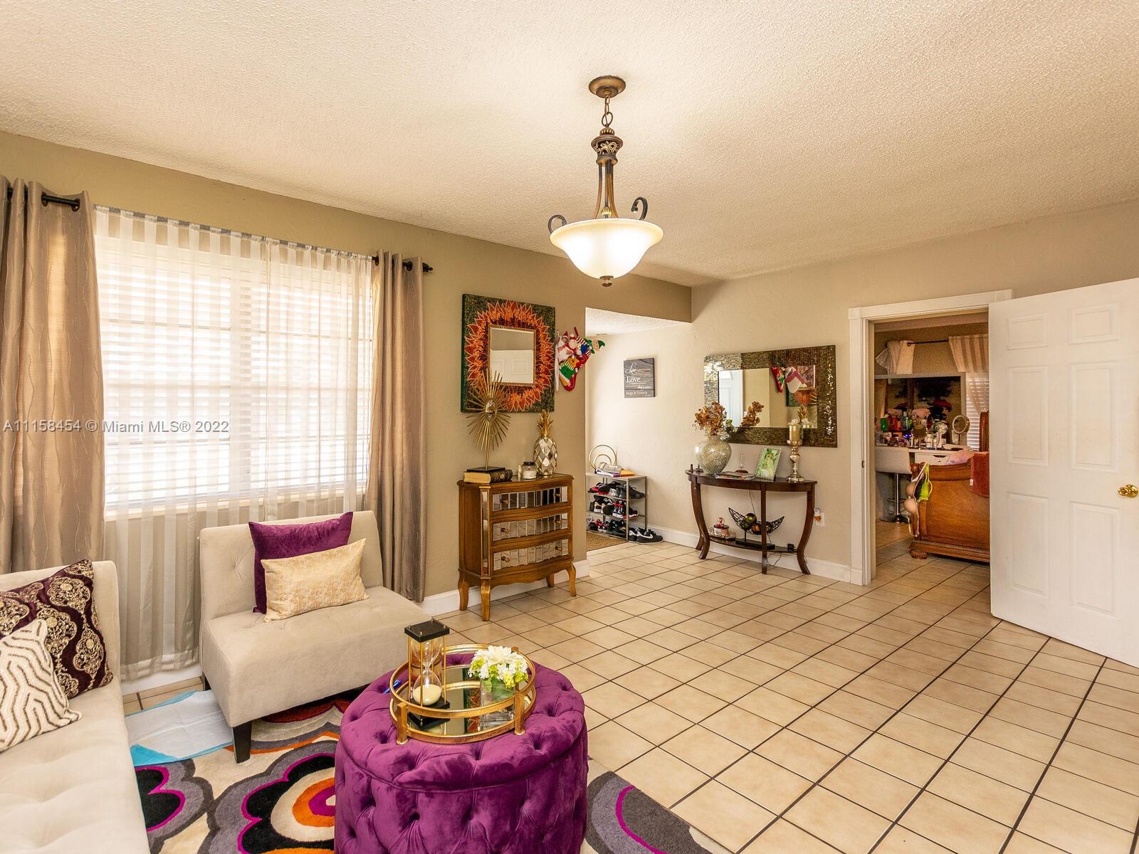 6731 Southwest 5th Terrace Miami, FL 33144 - Photo 6 of 33 a living room with furniture and a chandelier