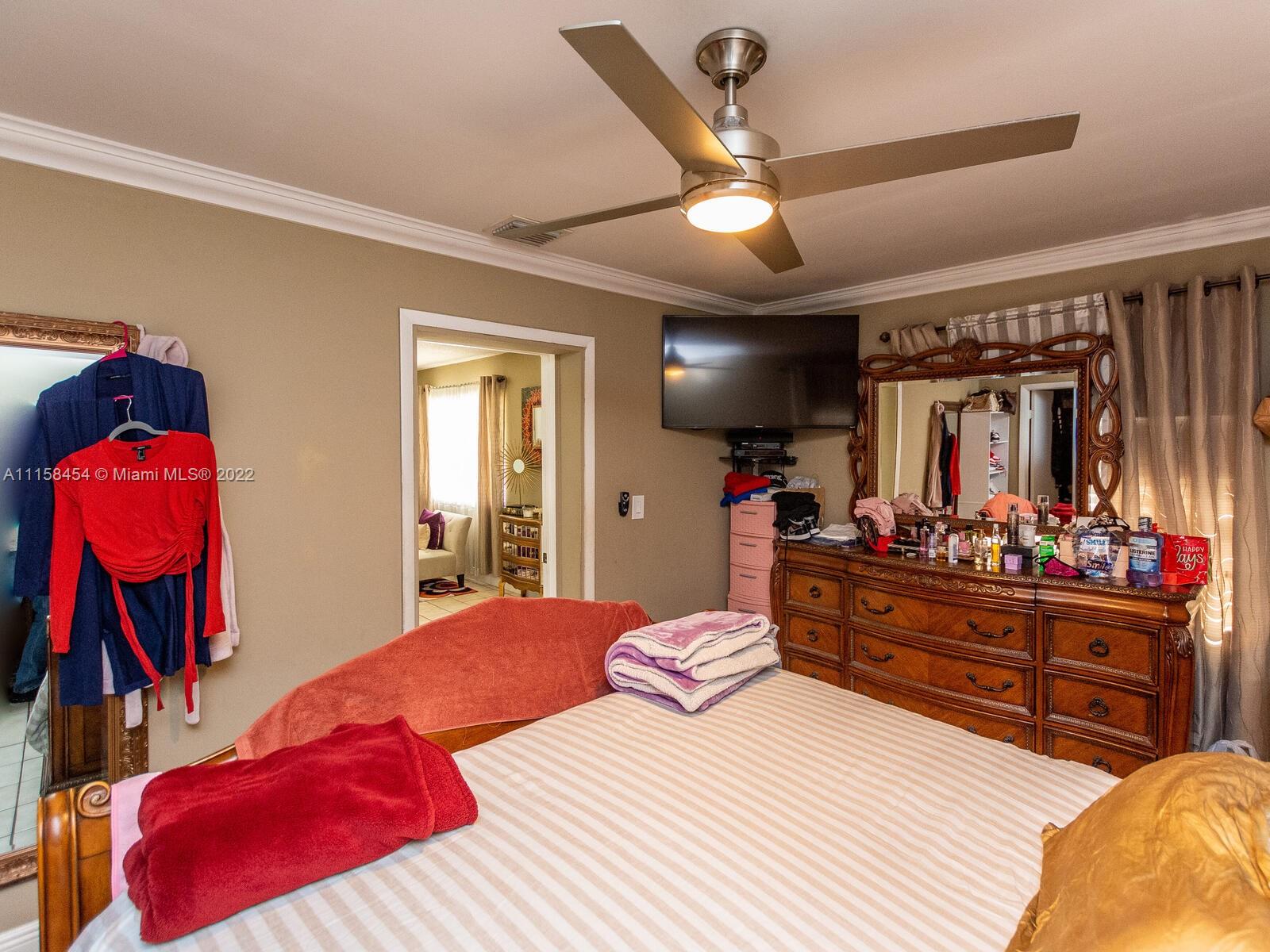 6731 Southwest 5th Terrace Miami, FL 33144 - Photo 10 of 33 a bedroom with a bed and a mirror