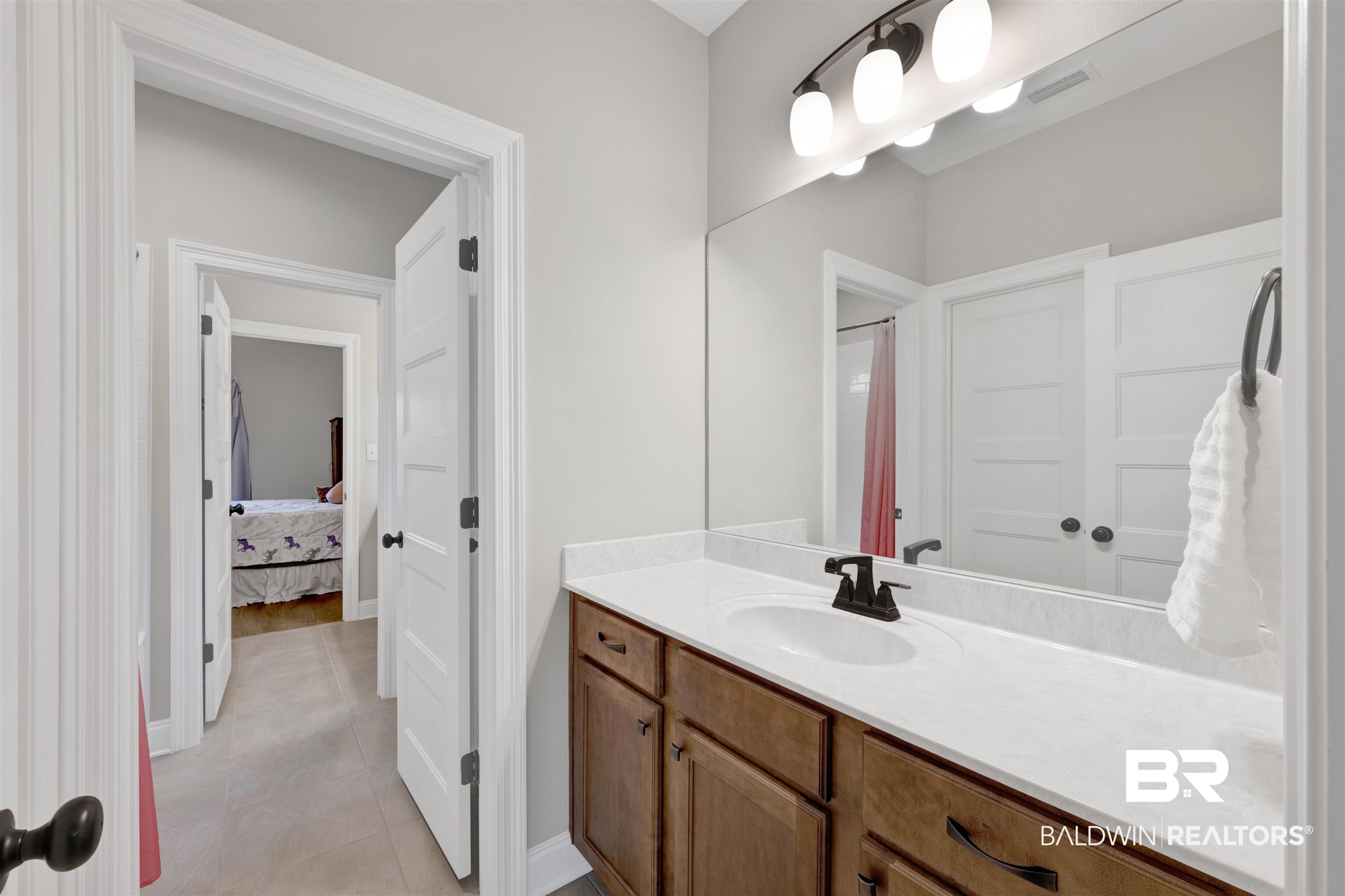 12672 Squirrel Drive Daphne, AL 36527 - Photo 30 of 49 Bathroom vanity with a white countertop, undermount sink, and dark bronze faucet