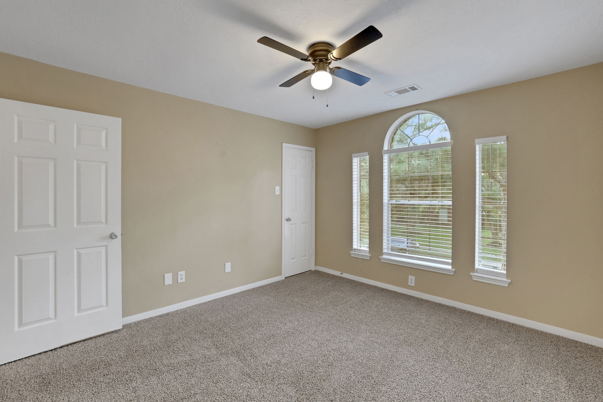 23207 Olive Ridge Court Katy, TX 77494 - Photo 35 of 46 an empty room with windows and ceiling fan