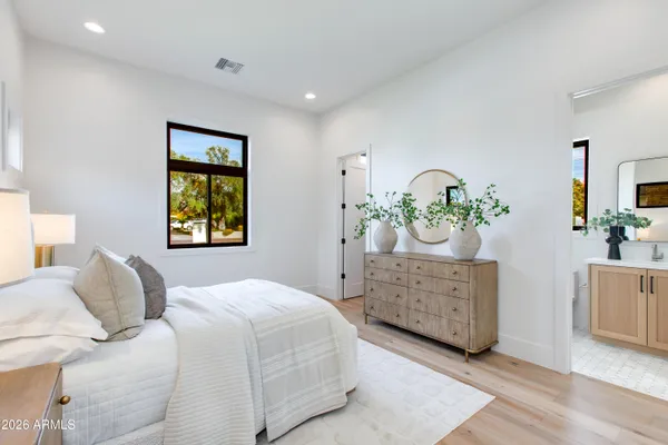 a bedroom with a bed and a night stand