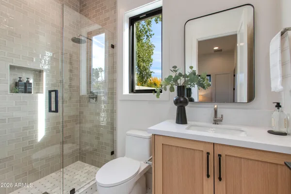 a bedroom with a large bed and a window