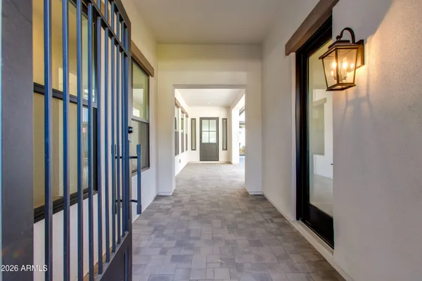 a view of a hallway with wooden floor and windows