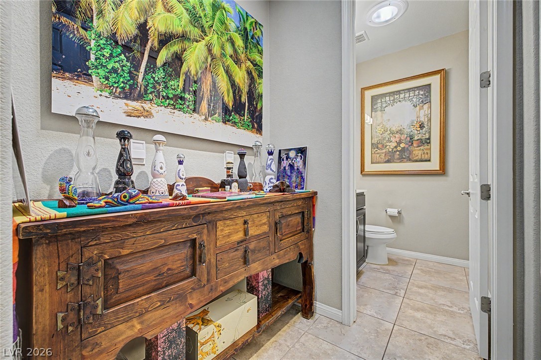 7415 Campbell Ranch Avenue Las Vegas, NV 89179 - Photo 24 of 52 Enter a thoughtfully designed space, featuring an inviting powder room with tiled flooring.