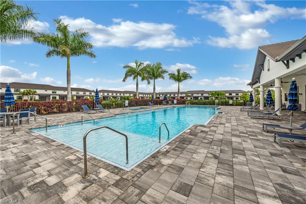 7549 Carnegie Way Naples, FL 34119 - Photo 17 of 22 a swimming pool with outdoor seating and yard