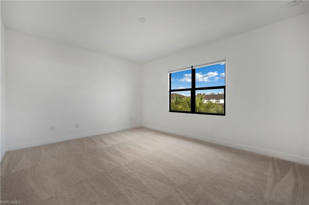 7549 Carnegie Way Naples, FL 34119 - Photo 6 of 22 an empty room with windows
