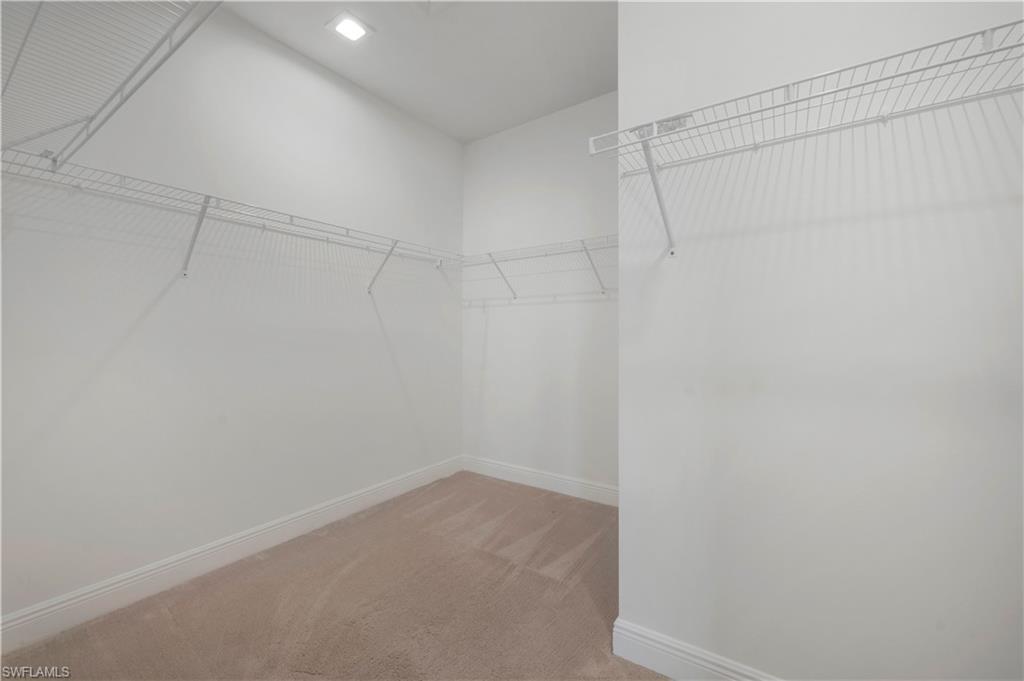 7549 Carnegie Way Naples, FL 34119 - Photo 8 of 22 a room that has a fan in it